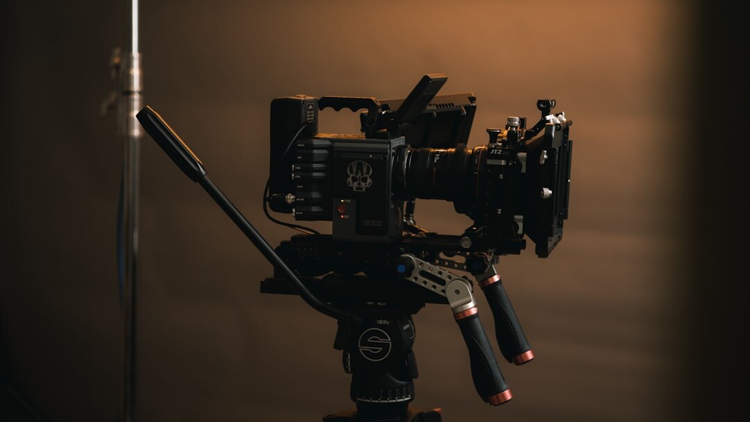 Small film set with camera on tripod and lighting rig during a shoot