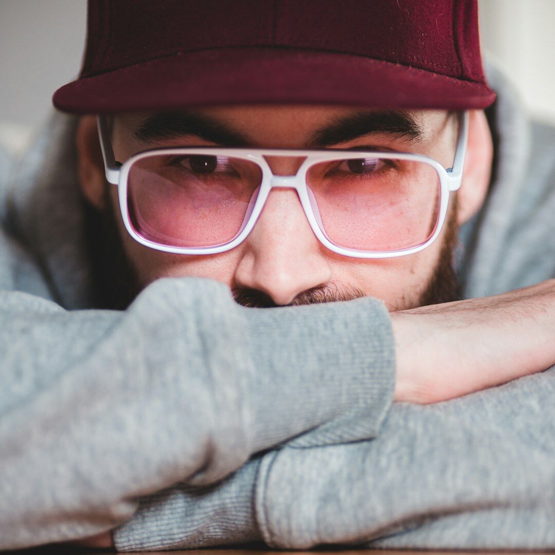 Studio portrait of a male motion designer wearing glasses
