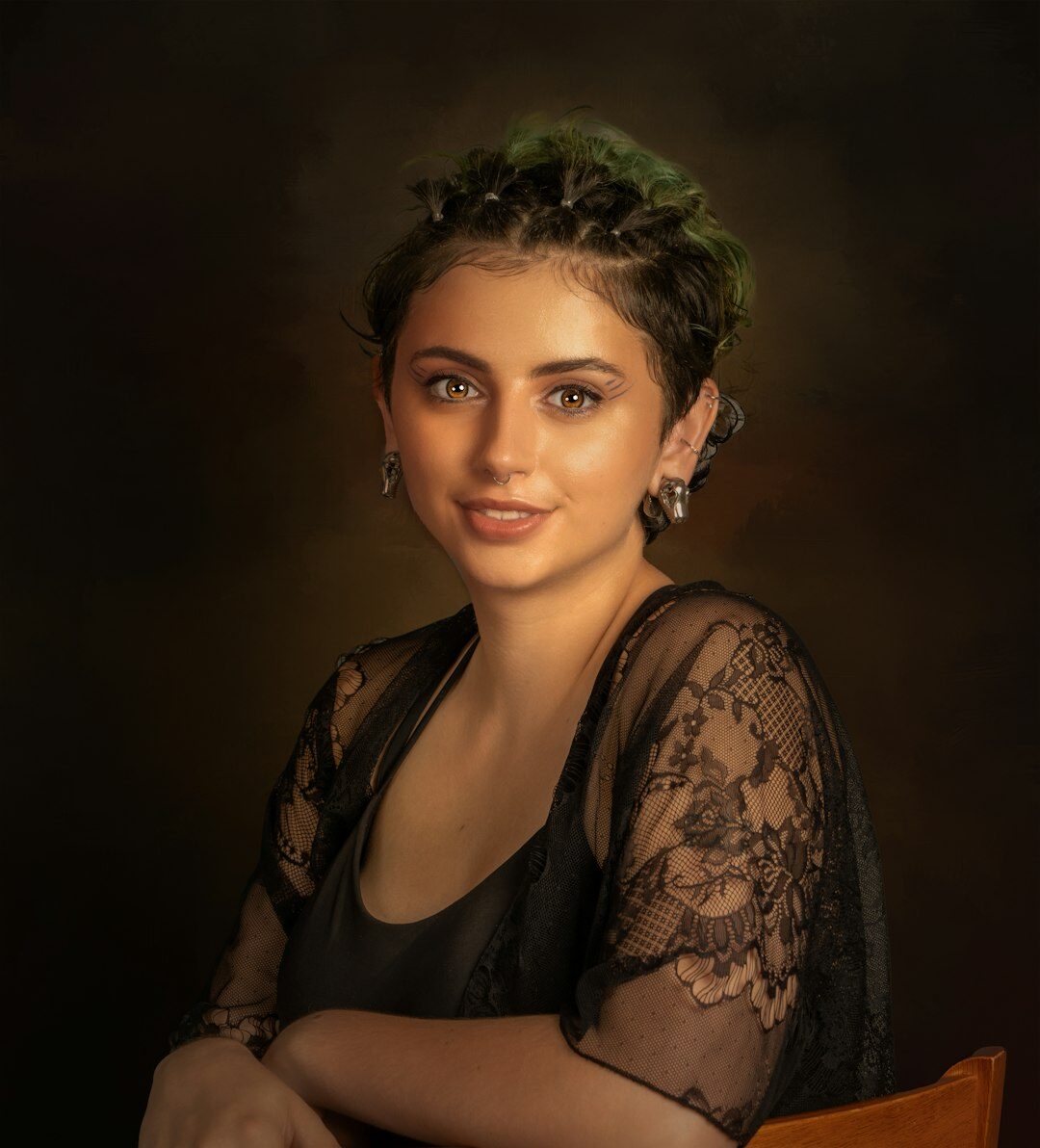Studio portrait of a woman video editor smiling at her desk